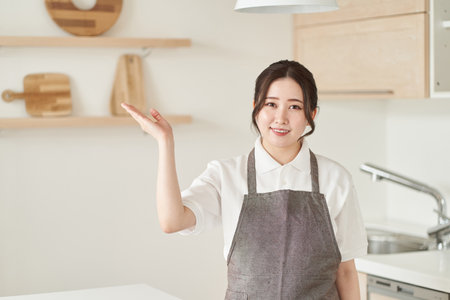 A woman in the housekeeping business to introduceの写真素材