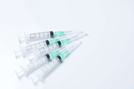 Multiple syringes placed on a white backgroundの写真素材