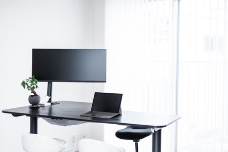 Work environment with laptop and external monitorの写真素材