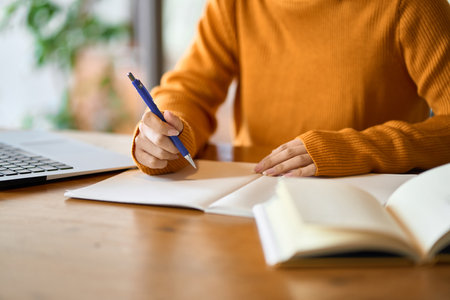 Asian woman's hand studying for qualificationsの写真素材