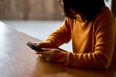 A woman who feels depressed looking at her smartphoneの写真素材