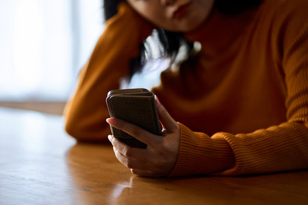 A woman who feels irritated by looking at her smartphoneの写真素材