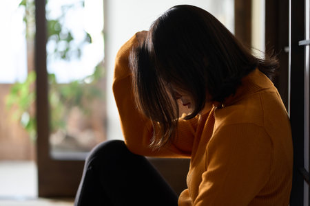 Anxious and depressed Asian womanの写真素材