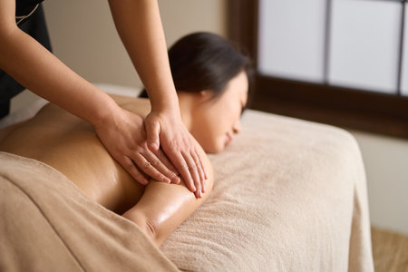 Woman receiving arm massage at beauty salonの写真素材
