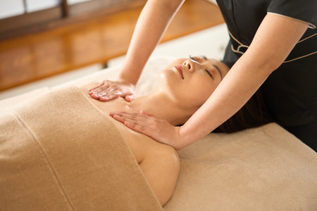 Woman receiving decollete massage at beauty salonの写真素材