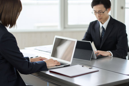 A business person who operates a laptop for desk workの写真素材