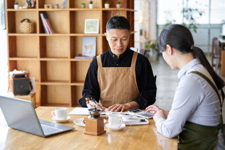 Asian businessman calculating the cost of productsの写真素材