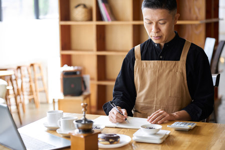 Asian businessman calculating the cost of productsの写真素材