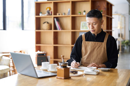Asian businessman calculating the cost of productsの写真素材