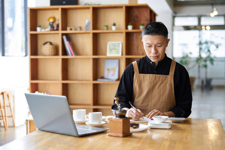 Asian businessman calculating the cost of productsの写真素材