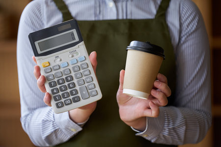 Cafe clerk with coffee and calculatorの写真素材