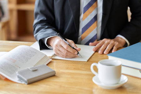Hands of a businessman gathering documents at a cafeの写真素材