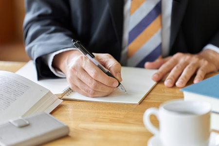 Hands of a businessman gathering documents at a cafeの写真素材