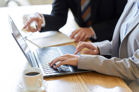Business woman learning work from seniorsの写真素材