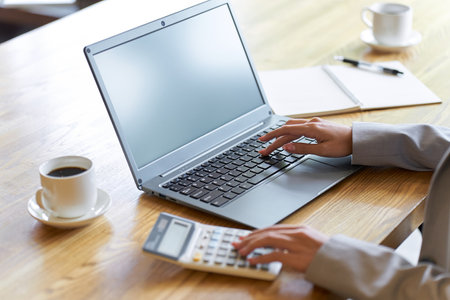 Business woman checking with a calculatorの写真素材