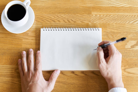 Hands of a businessman summarizing ideas in a blank notebookの写真素材