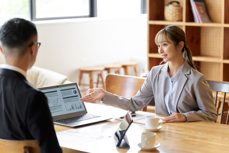 A business woman in a sales position giving an explanationの写真素材