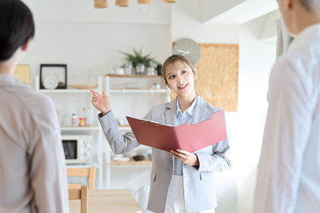 Asian woman guiding the roomの写真素材