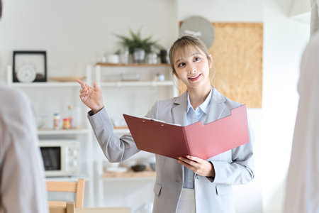 Asian woman guiding the roomの写真素材