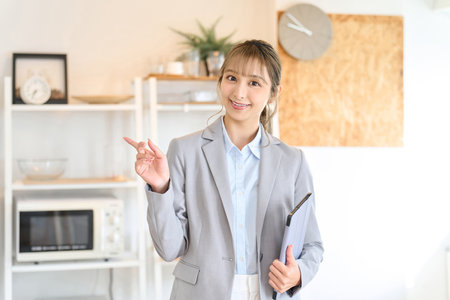Real estate sales staff providing room informationの写真素材