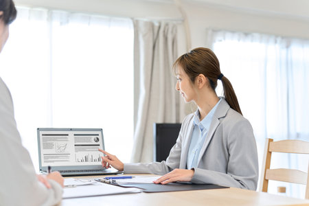 A female insurance agent giving information about insuranceの写真素材