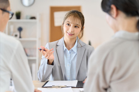A female insurance agent giving information about insuranceの写真素材