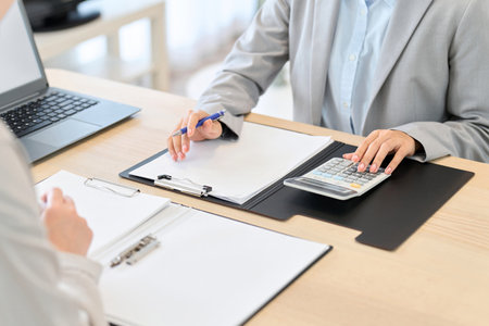 Business woman calculating an estimateの写真素材