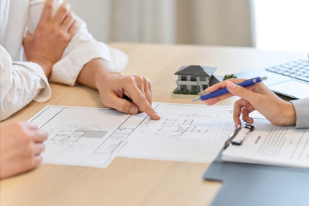 A man discussing the floor plan of a houseの写真素材