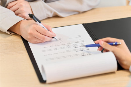 A woman signing a real estate contractの写真素材