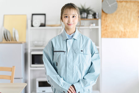 A professional woman wearing work clothes comes to your homeの写真素材