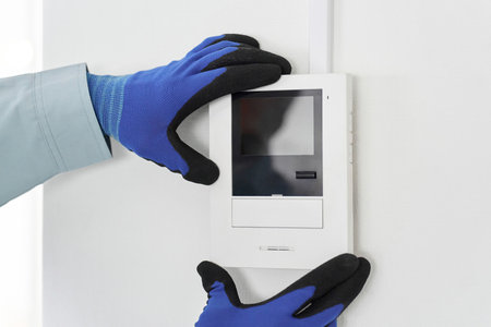 An electrician installing an intercom monitorの写真素材