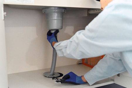 Plumber inspecting water equipmentの写真素材