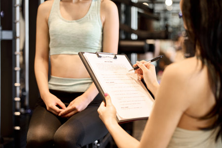 Female trainer giving counseling at the gymの写真素材