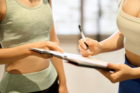 Female trainer giving counseling at the gymの写真素材