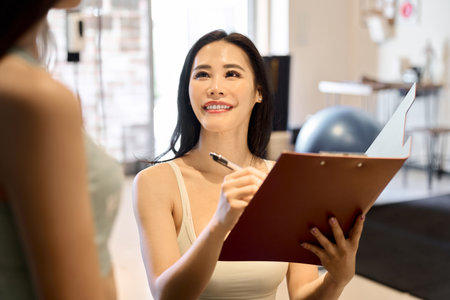 Female trainer giving counseling at the gymの写真素材