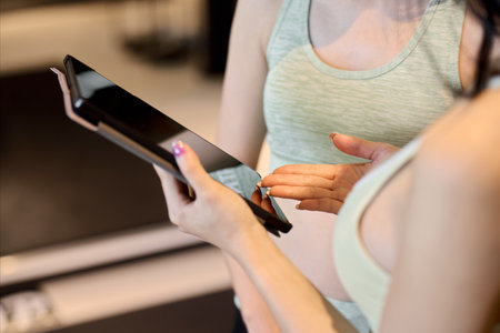 Trainer deciding on a training plan using a tabletの写真素材
