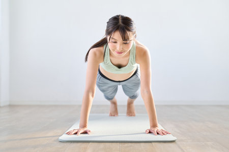 A woman doing push-ups with her own body weightの写真素材