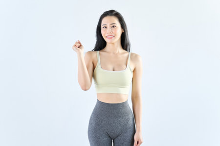 A woman wearing sportswear doing a fist pumpの写真素材