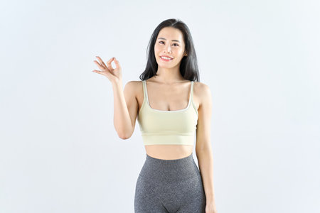A woman wearing sportswear giving an OK signの写真素材