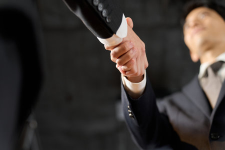 Asian business people shaking hands in the officeの写真素材