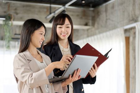 Business woman showing documents on computerの写真素材