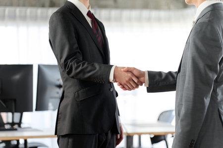 Asian business people shaking hands in the officeの写真素材