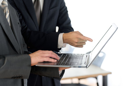Businessman showing documents on computerの写真素材