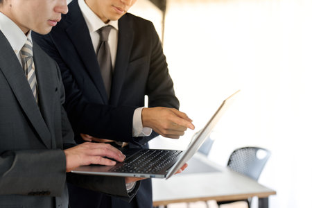 Businessman showing documents on computerの写真素材