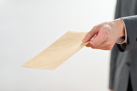 Businessman holding out an envelope
