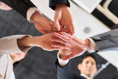 Asian business person clasping his hands together
