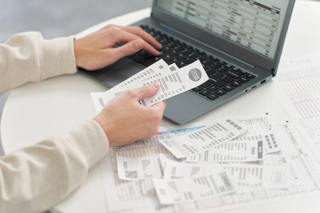 Hand of a man entering expenses into accounting softwareの写真素材