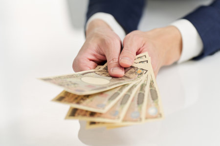 Hand of businessman paying moneyの写真素材