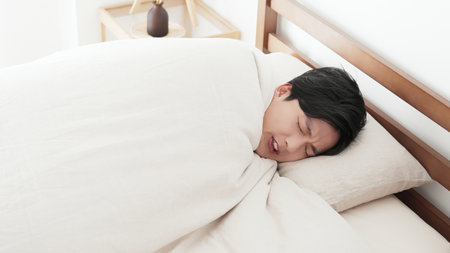 A man feels cold in bedの写真素材