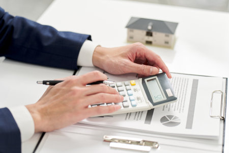 Businessman calculating money related to real estateの写真素材
